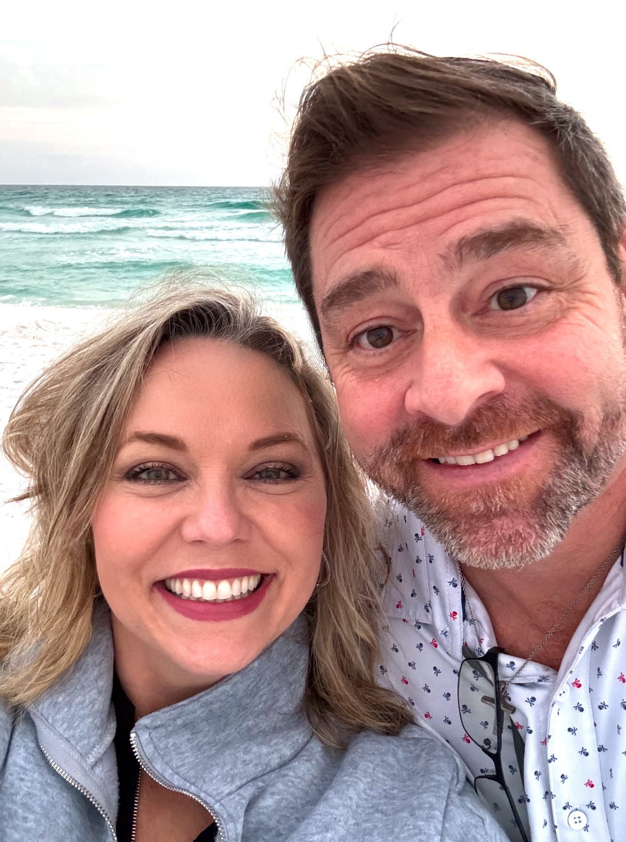 Dr. Melissa Shelton and Dr. Mike Wojnicki smiling together at the beach